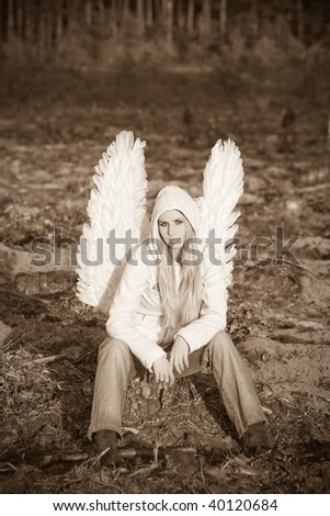 blonde girl with long hair and angel's wings on back and white hood
