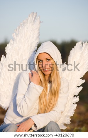 blonde girl with long hair and angel\'s wings on back and white hood