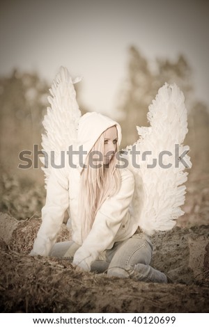 blonde girl with long hair and angel\'s wings on back and white hood, fallen angel