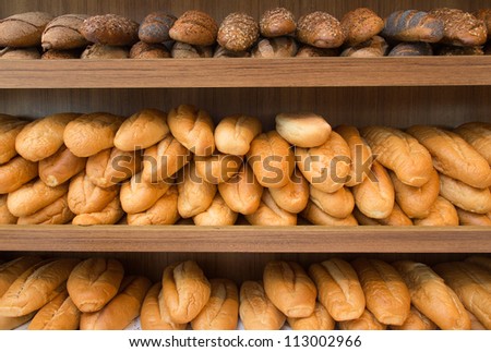 Rows of fresh bread loafs lying on the shelf