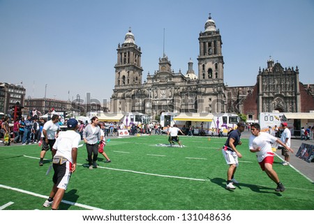 MEXICO CITY -MARCH, 3, 2012: Mexican people play rugby on an artificial field on Zocalo  in front of the Cathedral Metropolitana on march 3, 2012 in Mexico City, Mexico.