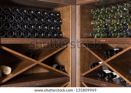 Wine cellar with bottles on wooden shelves