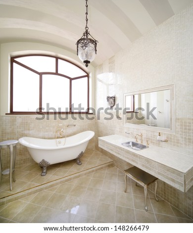 Vintage beige color bathroom with a golden sanitary engineering