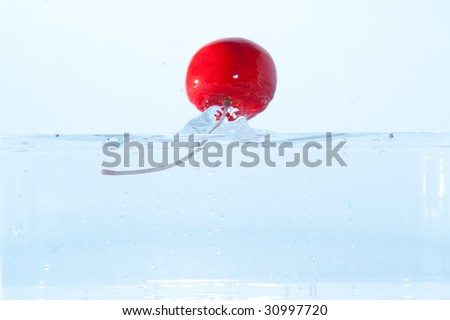 red cherry falling in water
