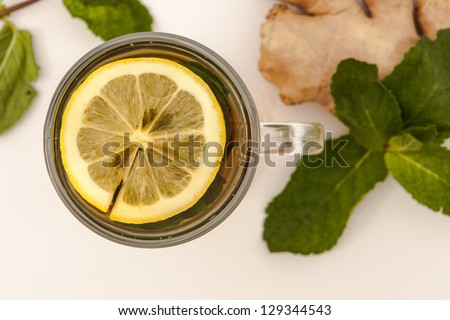 Cup tea with mint and lemon isolated on a white background