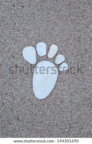 stone foot prints on sand