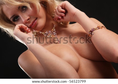 stock photo nude beautiful girl with jewellery on black background