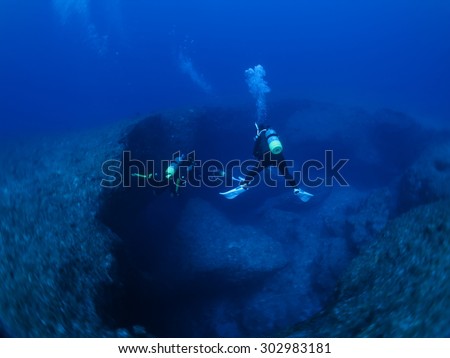 Exploring divers in the deep sea scuba diving Okinawa,Japan