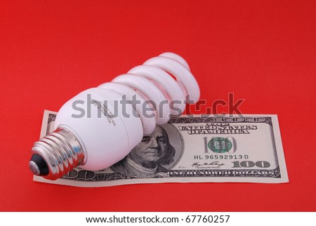 Luminescent lamp on hundred dollars. On red background