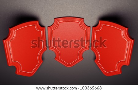 Three red labels or tags over black leather background. Large resolution