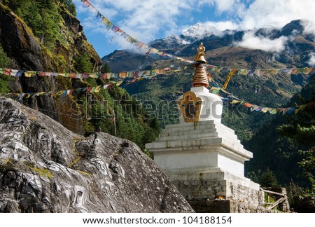 Buddhist stupe or chorten with prayer flags in Himalayas. Religion in Nepal