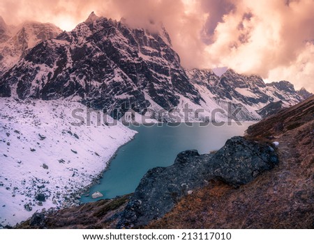Sunset landscape in the Mountains. Lake, snow, and Himalaya summits