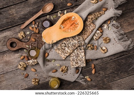 Cut Pumpkin with  honey, cookies and seeds on wooden table. Food in autumn. Rustic style