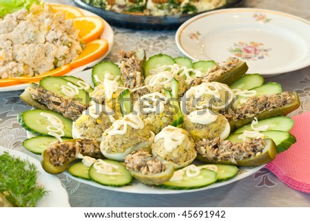 Stuffed eggs and cucumbers. Banquet in the restaurant. Focused on one dish (shallow DOF)