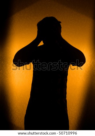Depression and pain - silhouette of man in the darkness