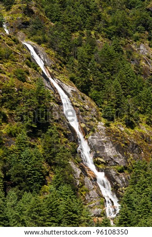 Himalaya Landscape: waterfall and forest trees. Travel to Nepal
