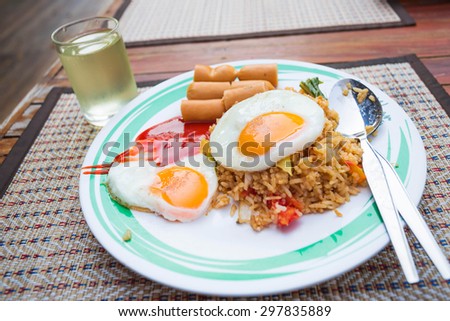 Close up American fried rice on wooden table (Called Kaw Pad American or American fried rice), Thai food.