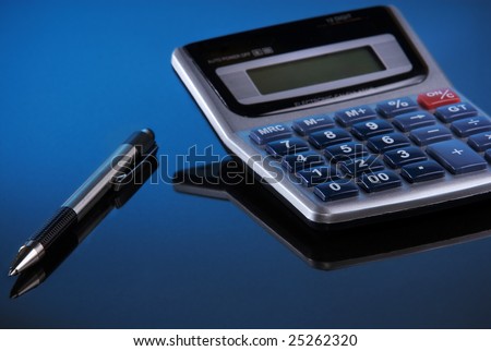 An ink pen and calculator ready to help figure out finances.