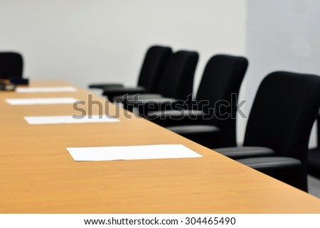 Preparation for a company business meeting (Chairs, table, reports)