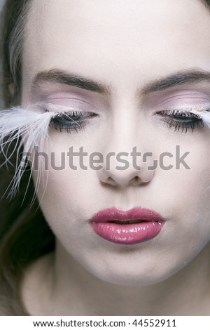 Portrait of pretty woman with covered eyes and long white eyelashes