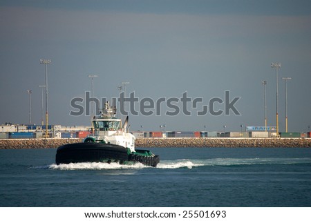 A tug boat moves through the main channel at the Port of Los Angeles.