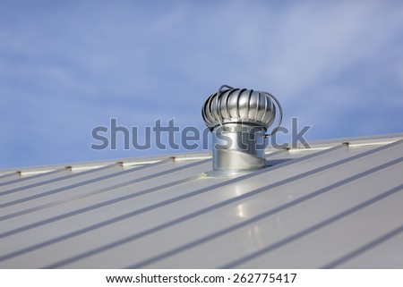 Stock photo of an attic vent on a freshly installed, brand new metal roof at a residential home.