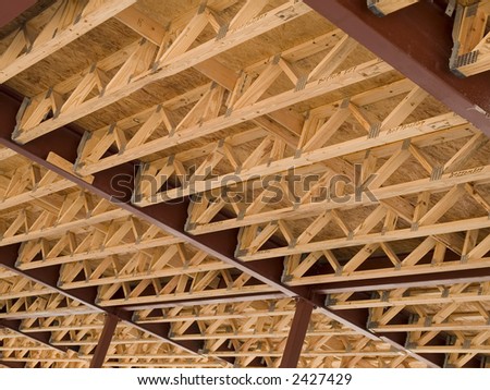 Stock photo of the wood frames of the second floor of a new urban housing development under construction.