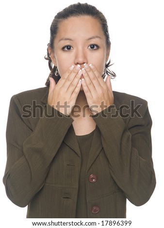 Isolated studio shot of a businesswoman in the Speak No Evil pose.