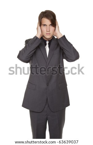 Isolated studio shot of a businessman in the Hear No Evil pose.