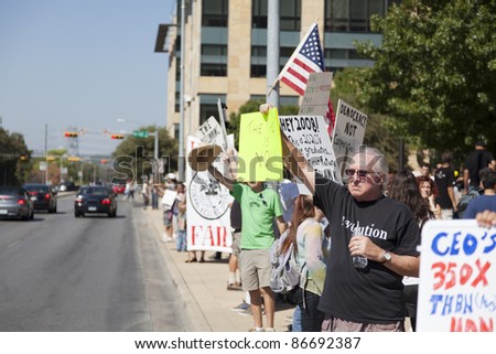 AUSTIN, TX - OCTOBER 15: Unidentified protestors greet traffic along Cesar Chavez Street prior to the \'Occupy Austin\' march to the Texas State Capitol on October 15, 2011 in Austin.