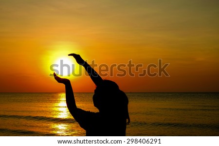 Woman enjoying the sun set on the beach.