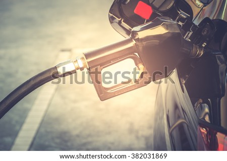 Car refueling on a petrol station. To fill the machine with fuel. Car refueling with gasoline at a gas station. Fuel pump at a station. Close up.