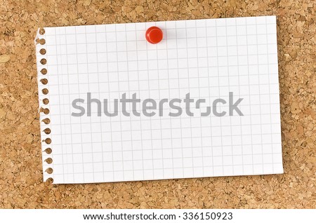 Blank squared note page fixed on cork board with thumb tack