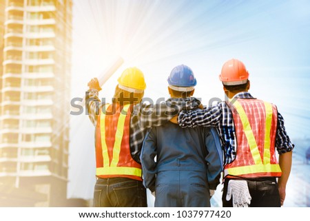 Team Construction asia workers are both engineers and builders are proud to succeed in the design and construction of buildings for Foreign customers. Good teamwork concept.