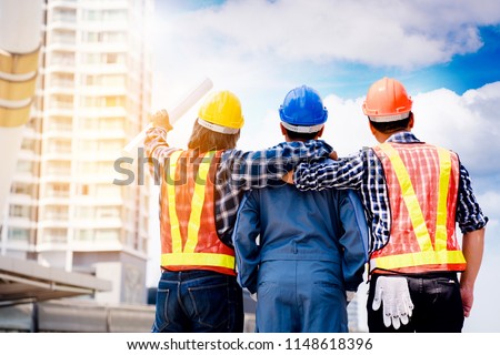 Team Construction asian workers are both engineers and builders are proud to succeed in the design and construction of buildings for Foreign customers. Good teamwork concept.