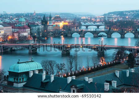 Panoramic view on Charles bridge and evening Prague lights.  Beautiful famous place in Bohemia.