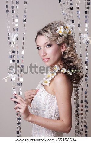 beautiful bride with wedding hairstyle and flowers