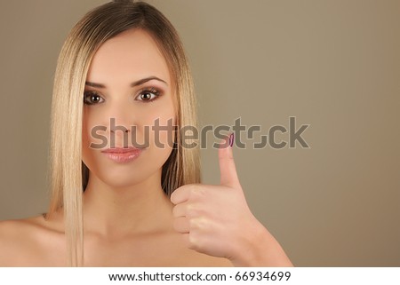 Woman showing ok sign and smiling on isolated white