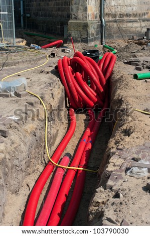 red electric cables in the ground