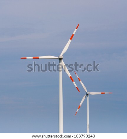 two windmills against a blue sky