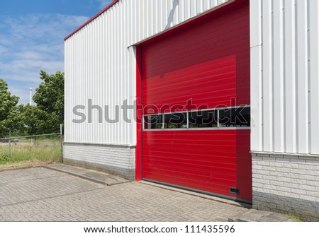 industrial warehouse with red roller door