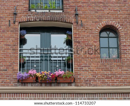flower boxes with blooming flowers in a window in Groningen, Netherlands