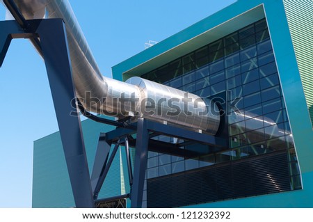 exterior of a modern waste treatment plant with giant pipes