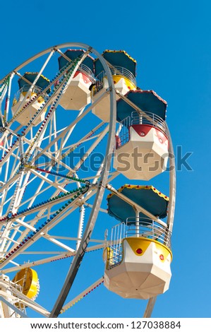 detail of a large ferris wheel against a blue sky
