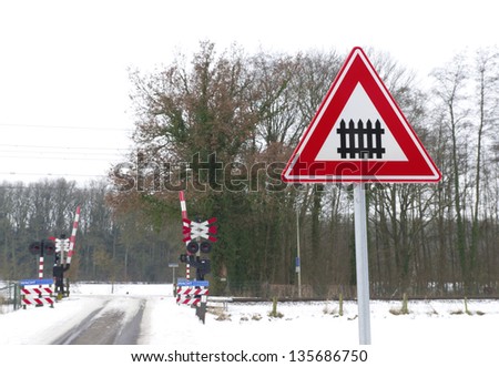 traffic sign approaching a railroad secured with automatic gate