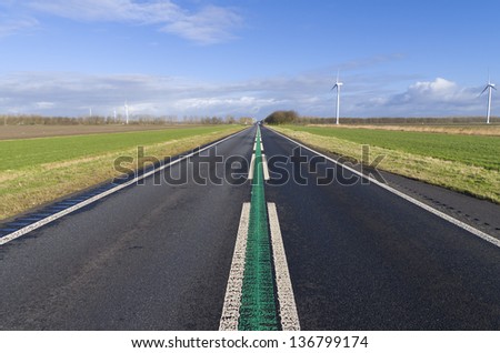 straight road in the netherlands. The green line in the middle means a speed limit of 100 kilometers per hour