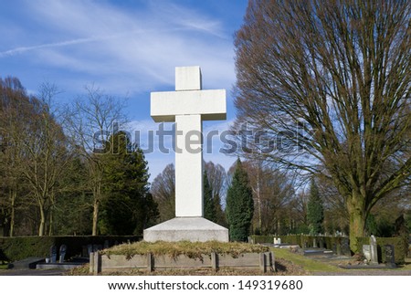 large white cross on a cemetery