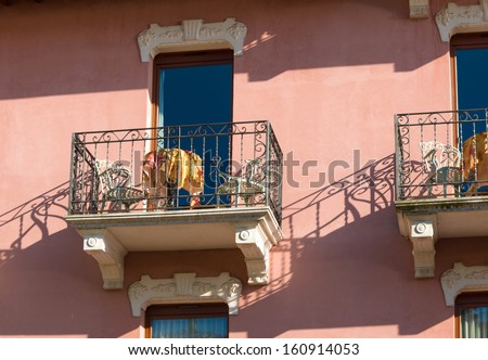 picturesque hotel balconies with table and chairs in a small touristic Italian village