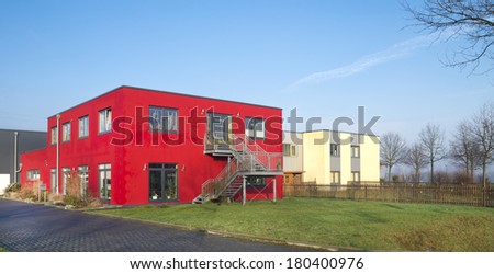 red house on an industrial area