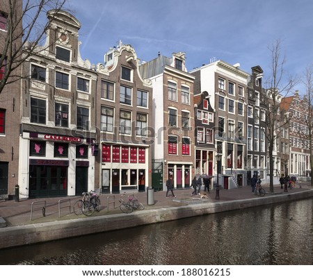 AMSTERDAM - FEBRUARY 23, 2013: Red light district at daylight. Since Oct 2000, window prostitutes have been allowed to legally ply their trade. Today, prostitutes in the Netherlands are also taxpayers